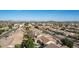 The aerial view highlights homes with red-tiled roofs in a planned community near desert mountain landscapes at 4614 W Fallen Leaf Ln, Glendale, AZ 85310