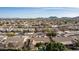 An aerial view of homes featuring desert landscaping, red tile roofs in a community near the mountains at 4614 W Fallen Leaf Ln, Glendale, AZ 85310