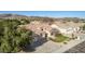 An aerial view of the home with desert landscaping including mature trees and shrubs at 4614 W Fallen Leaf Ln, Glendale, AZ 85310