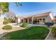 Spacious backyard featuring a pool, patio, lush lawn, and desert landscaping for outdoor enjoyment at 4614 W Fallen Leaf Ln, Glendale, AZ 85310