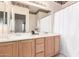 Well-lit bathroom with a double sink vanity and framed mirror at 4614 W Fallen Leaf Ln, Glendale, AZ 85310