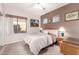 Neutral-toned bedroom with ample natural light, decorative art, and a comfortable bed at 4614 W Fallen Leaf Ln, Glendale, AZ 85310