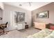 Versatile room with large window, functional furniture, and neutral carpeting at 4614 W Fallen Leaf Ln, Glendale, AZ 85310