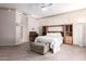 Spacious bedroom featuring a ceiling fan, a plush ottoman, and decorative built-ins at 4614 W Fallen Leaf Ln, Glendale, AZ 85310