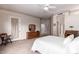 Bright bedroom with a large door, a decorative mirror, and neutral decor at 4614 W Fallen Leaf Ln, Glendale, AZ 85310