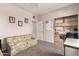 Functional room featuring built-in shelving, comfortable seating, and neutral carpet at 4614 W Fallen Leaf Ln, Glendale, AZ 85310