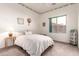 Cozy bedroom with sunflower accents, a large window, and neutral-toned carpet at 4614 W Fallen Leaf Ln, Glendale, AZ 85310