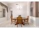 Cozy dining area with carpet, chandelier, wood table, and a view into other rooms at 4614 W Fallen Leaf Ln, Glendale, AZ 85310