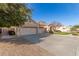 Lovely single-story house with a three-car garage, mature shade tree, and desert landscaping at 4614 W Fallen Leaf Ln, Glendale, AZ 85310