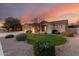 Beautiful single-story house with landscaped front yard, lush green lawn, and desert landscaping at 4614 W Fallen Leaf Ln, Glendale, AZ 85310