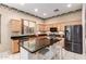 Spacious eat-in kitchen features an island with bar seating, stainless steel appliances, and wood cabinetry at 4614 W Fallen Leaf Ln, Glendale, AZ 85310
