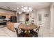 Bright eat-in kitchen featuring natural light, a round dining table, and bar seating at 4614 W Fallen Leaf Ln, Glendale, AZ 85310