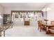 Bright living room featuring large windows with decorative valances, chandelier, and carpet at 4614 W Fallen Leaf Ln, Glendale, AZ 85310