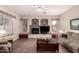 Cozy living room featuring a fireplace, tile flooring, a ceiling fan and comfortable furnishings at 4614 W Fallen Leaf Ln, Glendale, AZ 85310