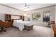 Bright main bedroom featuring a ceiling fan, carpeted floors and generous natural light at 4614 W Fallen Leaf Ln, Glendale, AZ 85310