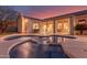 Backyard view of a pool with covered patio at dusk at 4614 W Fallen Leaf Ln, Glendale, AZ 85310
