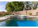 Tranquil pool with a cascading water feature and a spa, offering a serene backyard retreat at 4614 W Fallen Leaf Ln, Glendale, AZ 85310