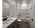 This bathroom features a shower and tub combination, vanity, and tile flooring at 47251 W Mellen Ln, Maricopa, AZ 85139