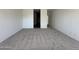 Large bedroom with carpeted floors offers a comfortable space for relaxation and personalization at 47251 W Mellen Ln, Maricopa, AZ 85139