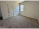 Neutral bedroom featuring plush carpet, a window with a view, and fresh paint at 47251 W Mellen Ln, Maricopa, AZ 85139