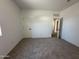 Bright bedroom featuring fresh paint, new carpet, and a door to the hallway at 47251 W Mellen Ln, Maricopa, AZ 85139