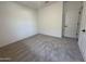 Carpeted bedroom offering crisp walls, a spacious closet, and a hallway view at 47251 W Mellen Ln, Maricopa, AZ 85139