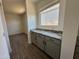 This butlers pantry features a granite countertop and ample cabinet space at 47251 W Mellen Ln, Maricopa, AZ 85139