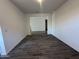 This living room features an open layout and hardwood-style flooring at 47251 W Mellen Ln, Maricopa, AZ 85139