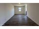 Open-concept living room featuring tile flooring, neutral paint, and plenty of natural light at 47251 W Mellen Ln, Maricopa, AZ 85139