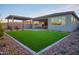 Expansive backyard featuring pavers, artificial turf, and desert landscaping at 4924 W Capistrano Ave, Laveen, AZ 85339