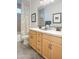 Bright bathroom featuring a double vanity, stylish mirrors, and a patterned shower curtain, combining function with style at 4924 W Capistrano Ave, Laveen, AZ 85339