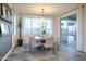 Bright dining area with a modern chandelier and sliding glass doors leading to the patio at 4924 W Capistrano Ave, Laveen, AZ 85339
