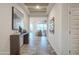 Bright and airy entryway with tiled floor, console table with decor, and view into the open living space at 4924 W Capistrano Ave, Laveen, AZ 85339