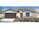 Inviting single-story home with neutral stucco, brick accents, desert landscaping, and an attached two-car garage at 4924 W Capistrano Ave, Laveen, AZ 85339