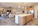 Open kitchen featuring a large island, stainless steel appliances, and adjacent living area at 4924 W Capistrano Ave, Laveen, AZ 85339