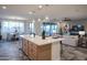 Open kitchen with a central island, seamlessly connecting to the dining and living spaces at 4924 W Capistrano Ave, Laveen, AZ 85339