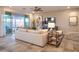 Comfortable living room with a modern ceiling fan, sofa, patterned rug and sliding door access to the backyard at 4924 W Capistrano Ave, Laveen, AZ 85339