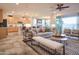 Open-concept living and dining area with bright cabinets and bar seating, a cozy sofa, and access to outdoor space at 4924 W Capistrano Ave, Laveen, AZ 85339