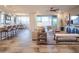 Open-concept living room and kitchen featuring bar seating, a cozy sofa, and access to the outdoor patio at 4924 W Capistrano Ave, Laveen, AZ 85339