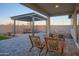 Charming patio with comfortable seating, a pergola, and lush landscaping, ideal for outdoor entertaining at 4924 W Capistrano Ave, Laveen, AZ 85339