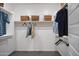 Organized walk-in closet with ample hanging space, shelving, and storage baskets at 4924 W Capistrano Ave, Laveen, AZ 85339