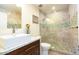 Bathroom with decorative-tiled shower, modern vessel sink, vanity and wood-look tile floors at 4950 N Miller Rd # 122, Scottsdale, AZ 85251