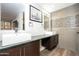 Modern bathroom with gray-tiled walls, white vessel sink and dark vanity at 4950 N Miller Rd # 122, Scottsdale, AZ 85251
