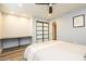 Bedroom with ceiling fan, wood-look floors, gray walls and sliding glass-door closet at 4950 N Miller Rd # 122, Scottsdale, AZ 85251