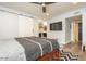 Bedroom with ceiling fan, TV and a sliding door closet in a modern-style home at 4950 N Miller Rd # 122, Scottsdale, AZ 85251