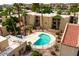 Inviting community pool nestled within lush landscaping and multi-story condo buildings at 4950 N Miller Rd # 122, Scottsdale, AZ 85251