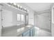 Bathroom with a vanity, large mirror, walk-in shower, and marble-style floors and walls at 5228 W Ironwood Dr, Glendale, AZ 85302