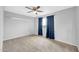 Bedroom with neutral carpet, ceiling fan, blue curtains and gray walls at 5228 W Ironwood Dr, Glendale, AZ 85302