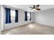Bedroom with neutral carpet, ceiling fan, blue curtains and gray walls at 5228 W Ironwood Dr, Glendale, AZ 85302
