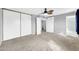 Bedroom with neutral carpet, ceiling fan, sliding closet doors, and gray walls at 5228 W Ironwood Dr, Glendale, AZ 85302